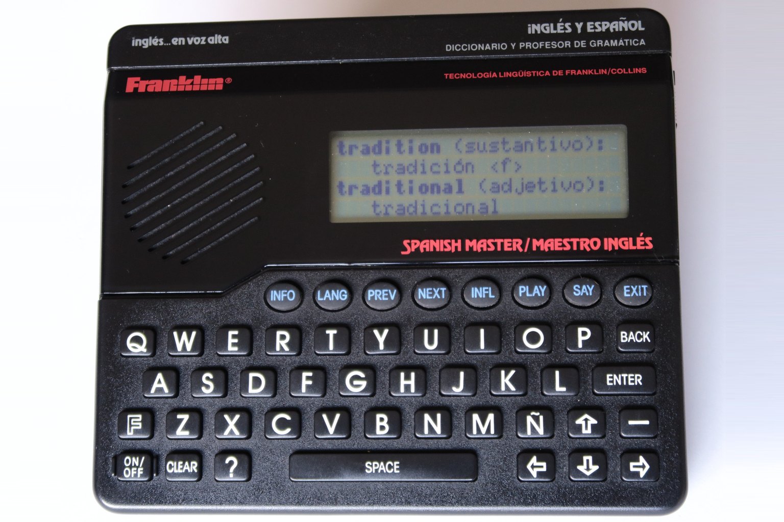 A Franklin Spanish Master handheld electronic dictionary with a QWERTY keyboard and a screen showing an English word with its Spanish translation