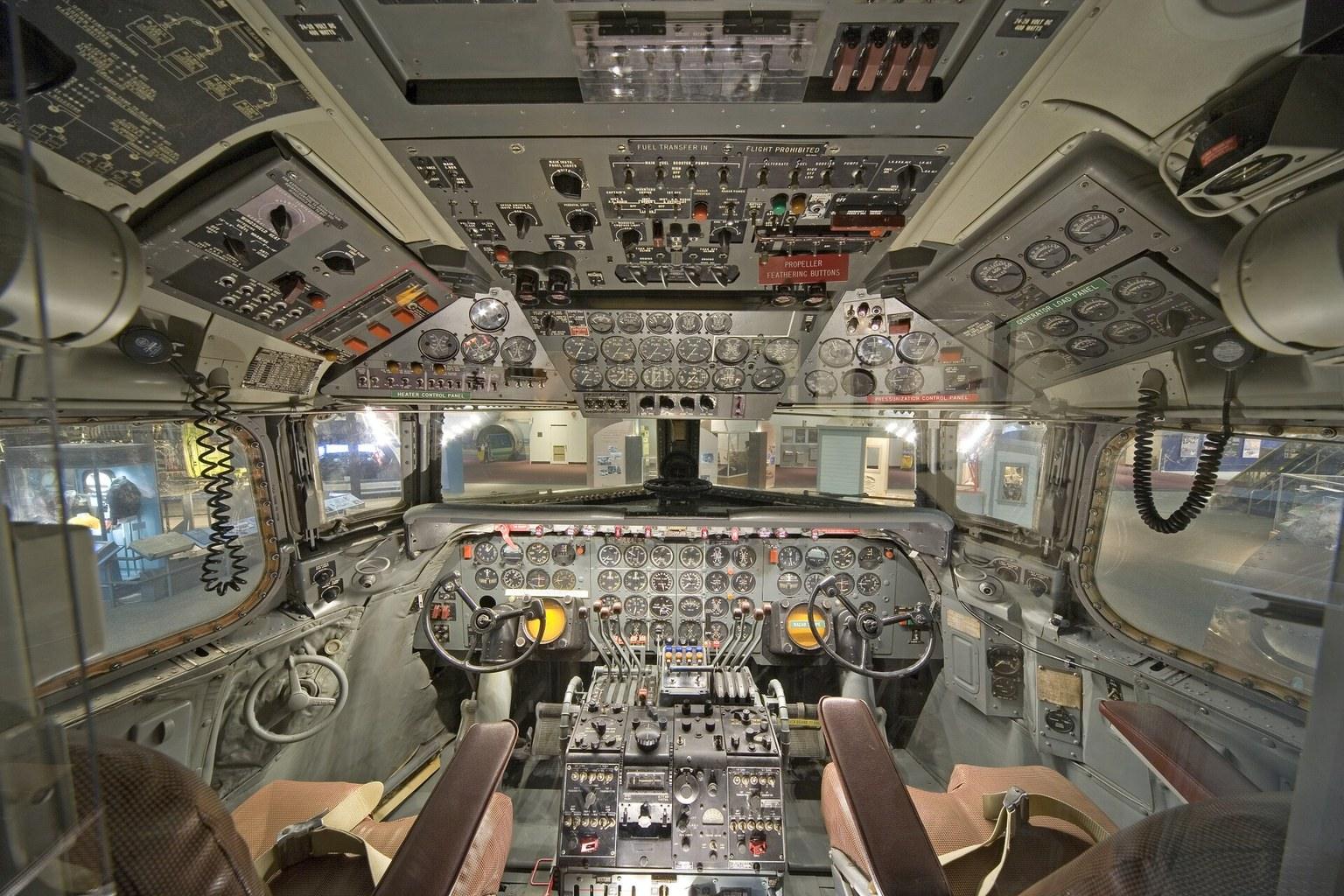 The flight deck of a Douglas DC-7 airliner, with four engine controls, analogue instrument panels and radio equipment