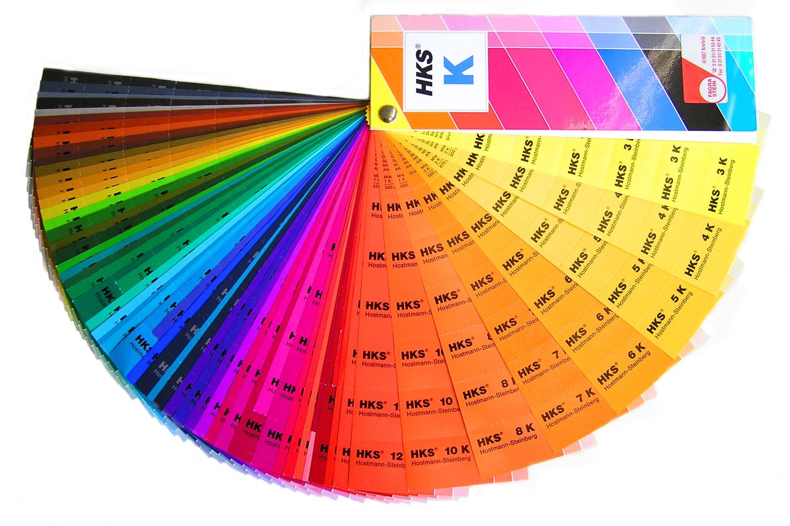 A colour fan from an industrial colour standard system opened out on a white surface, showing hundreds of numbered colour strips from greys through reds to yellows